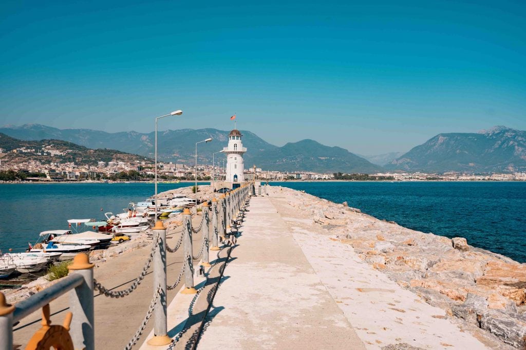 Beautiful nature landscape with mountains range, blu sky and lighthouse in port Alanya, Turkey